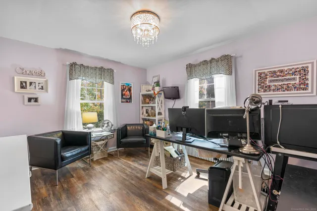 a view of a livingroom with workspace and a window