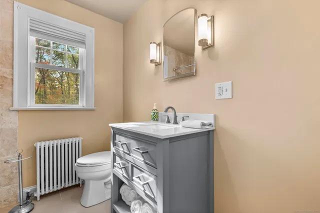 a view of a workspace with furniture and a window