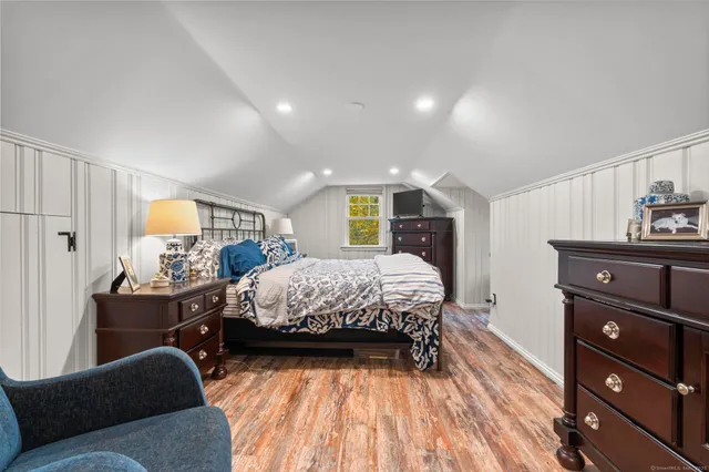 a bed room with a bed and a television