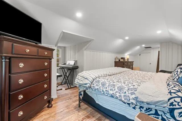 a bed sitting in a bedroom and mirror