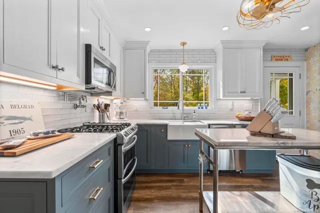 a kitchen with a sink stove and cabinets