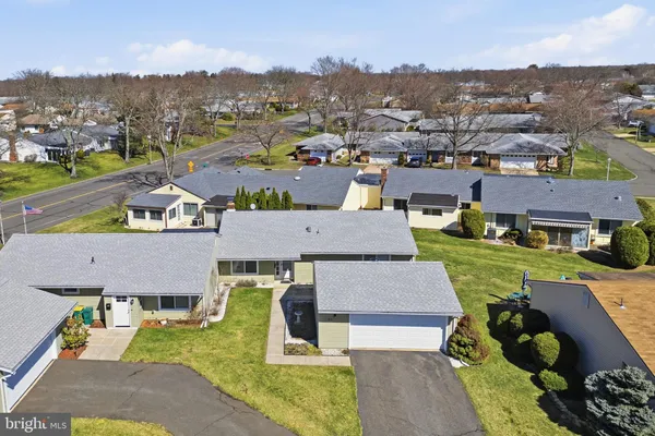 an aerial view of a house with a garden and lake view