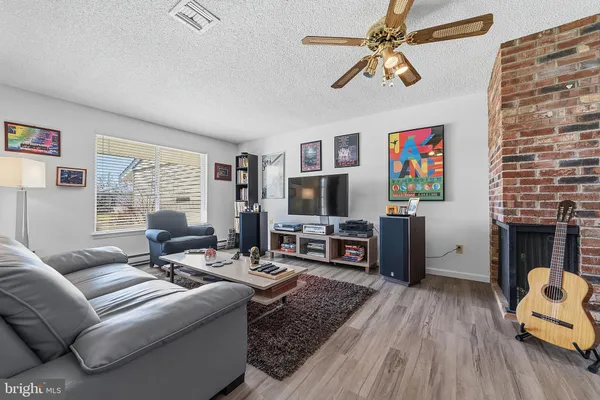 a living room with furniture a fireplace and a flat screen tv