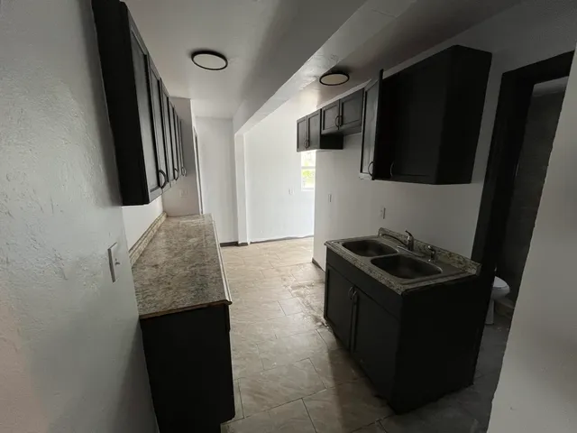 a kitchen with stainless steel appliances kitchen island a stove and a refrigerator