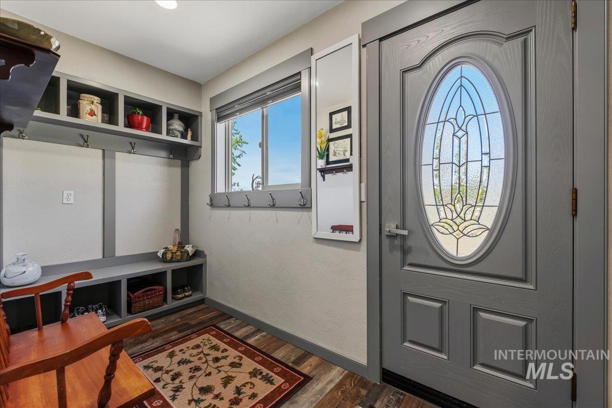 6323 Foothill Road Star, ID 83669 - Photo 7 of 50 Entry foyer featuring a decorative glass oval front door, built-in storage bench with cubbies, upper shelving, and coat hooks