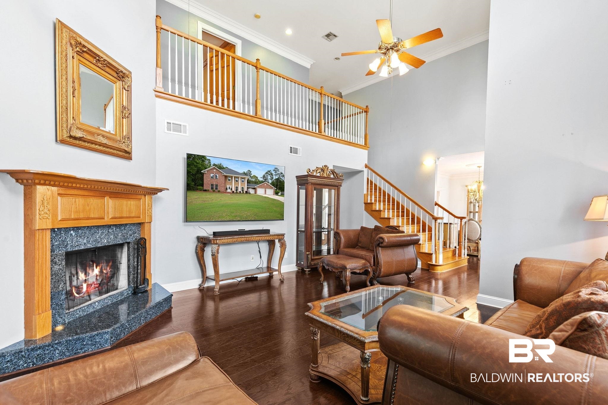 2 Speckle Trout Route Daphne, AL 36527 - Photo 12 of 61 Living area featuring a ceiling fan, a high ceiling, crown molding, dark wood-style floors, and a premium fireplace