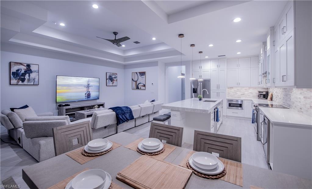 662 105th Avenue North Naples, FL 34108 - Photo 11 of 35 Dining room with recessed lighting, a ceiling fan, visible vents, and a raised ceiling