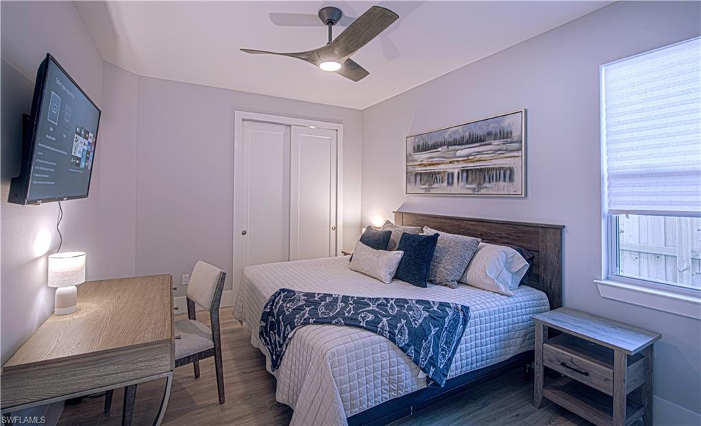 662 105th Avenue North Naples, FL 34108 - Photo 13 of 35 Bedroom featuring a ceiling fan, wood finished floors, and a closet