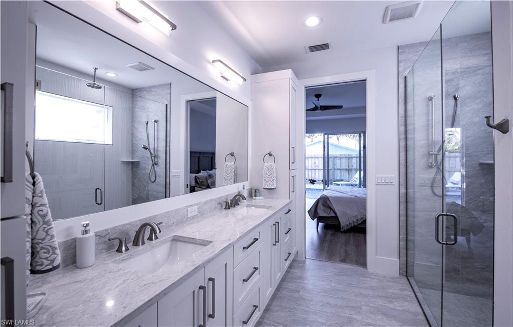 662 105th Avenue North Naples, FL 34108 - Photo 16 of 35 Bathroom with visible vents, a sink, and connected bathroom