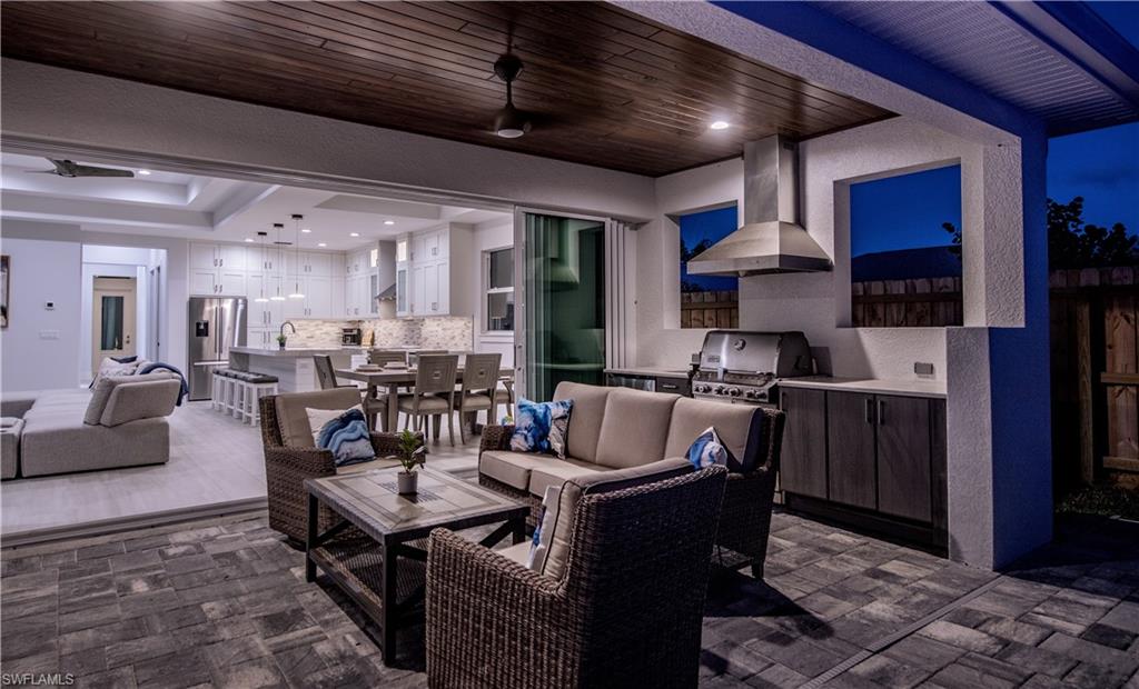 662 105th Avenue North Naples, FL 34108 - Photo 23 of 35 View of patio / terrace featuring outdoor lounge area, fence, a grill, an outdoor bar, and area for grilling