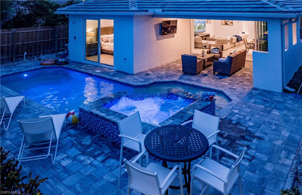 662 105th Avenue North Naples, FL 34108 - Photo 26 of 35 View of pool with a patio area, an outdoor hangout area, outdoor dining space, and an in ground hot tub
