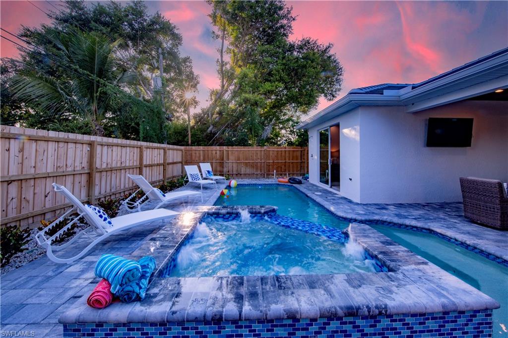 662 105th Avenue North Naples, FL 34108 - Photo 28 of 35 View of pool with a fenced backyard, a patio, a fenced in pool, and an in ground hot tub