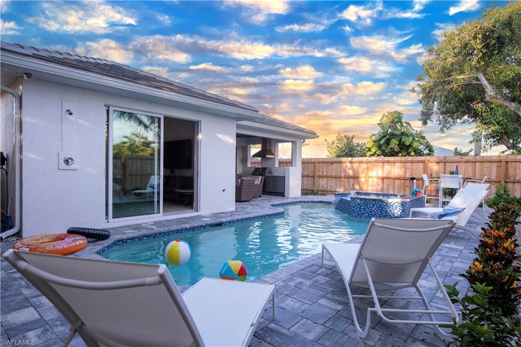 662 105th Avenue North Naples, FL 34108 - Photo 29 of 35 View of swimming pool with a patio area, a fenced backyard, a fenced in pool, and an in ground hot tub