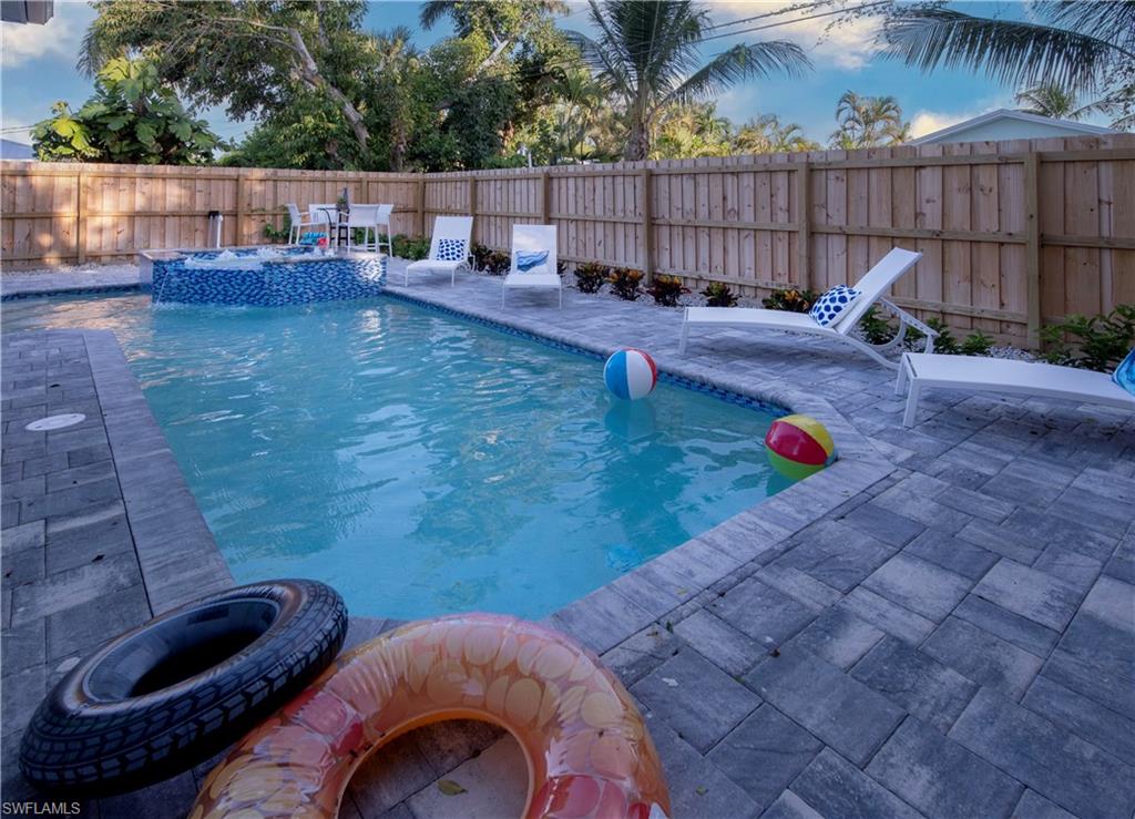 662 105th Avenue North Naples, FL 34108 - Photo 30 of 35 View of swimming pool featuring a fenced backyard, a patio, a fenced in pool, and an in ground hot tub