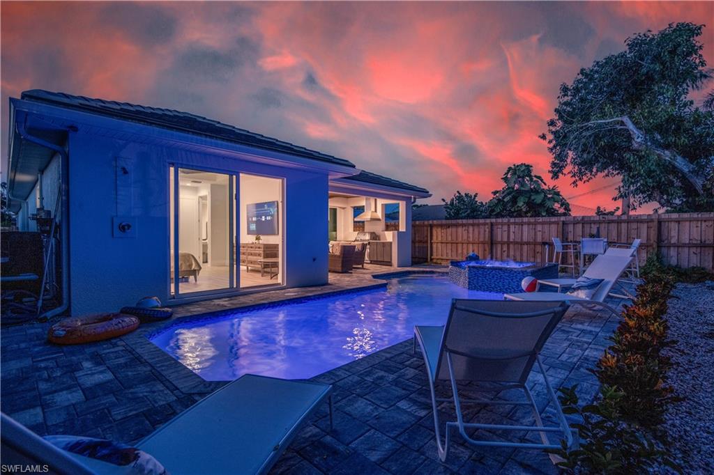662 105th Avenue North Naples, FL 34108 - Photo 33 of 35 View of pool with a jacuzzi, a fenced in pool, outdoor dry bar, a fenced backyard, and a patio