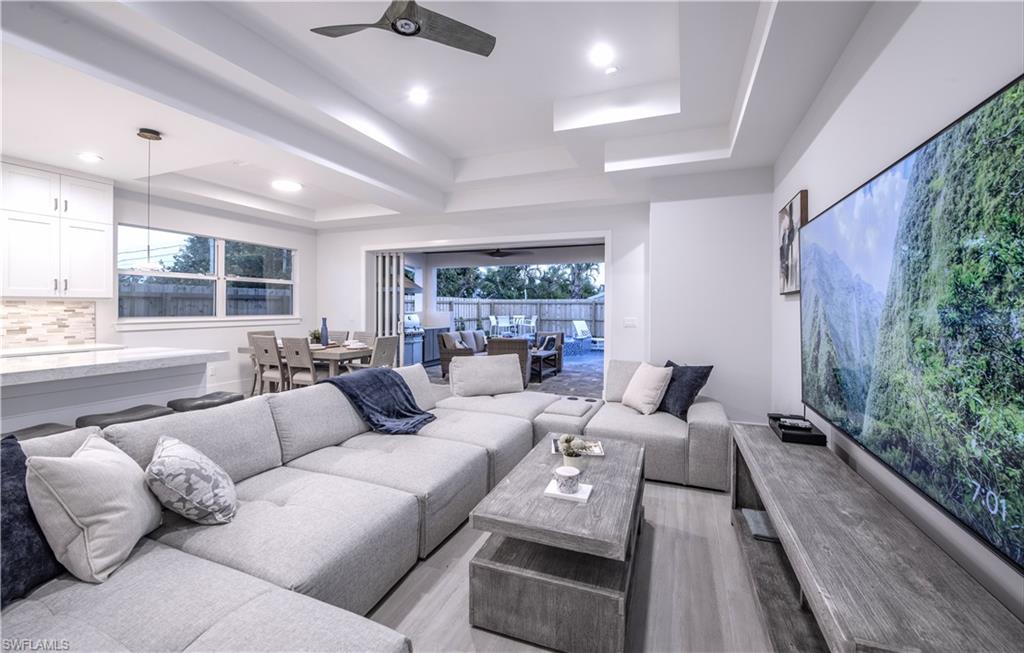 662 105th Avenue North Naples, FL 34108 - Photo 6 of 35 Living area featuring recessed lighting, a ceiling fan, light wood-style floors, and a raised ceiling