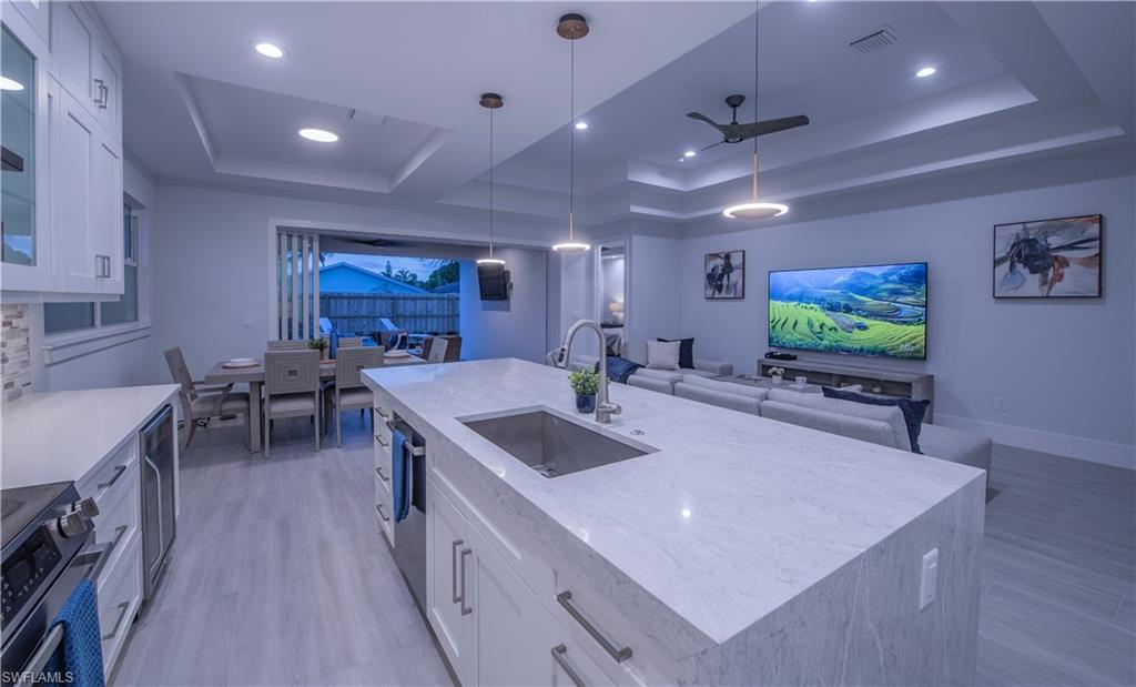 662 105th Avenue North Naples, FL 34108 - Photo 35 of 35 Kitchen with a ceiling fan, a sink, open floor plan, a raised ceiling, and visible vents
