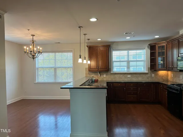 a kitchen with a sink and chandelier