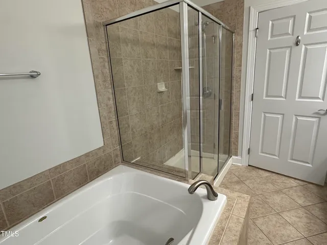 a bathroom with a bathtub and a shower