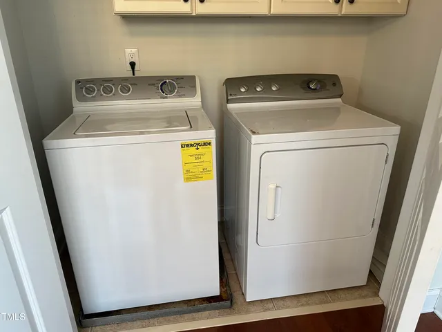 a view of balcony with two chairs and a window