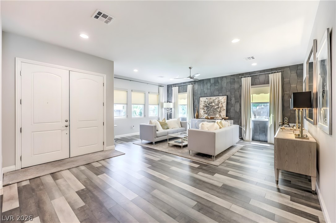 7119 Arabian Ridge Street Las Vegas, NV 89131 - Photo 11 of 73 Enter into a bright, open living space featuring patterned flooring and accent wall.