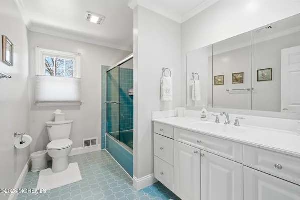 a spacious bathroom with a toilet sink and mirror