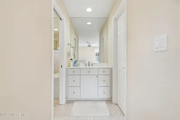 a bathroom with a sink vanity and a mirror