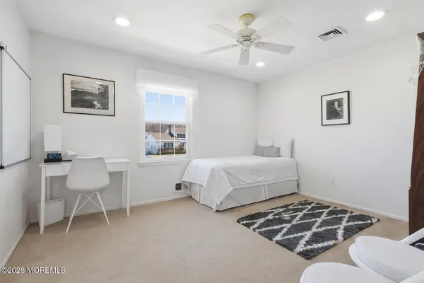 a bedroom with a bed and a chair