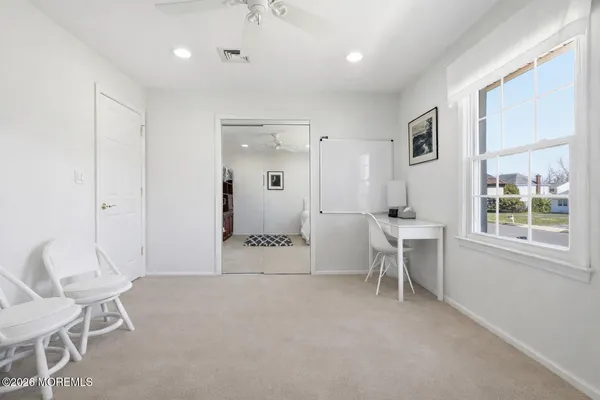 a living room with furniture a table and a large window