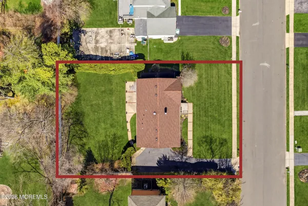 an aerial view of a house with a yard and