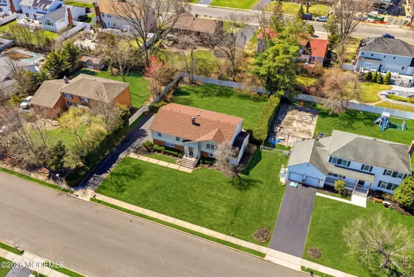 an aerial view of a house with a garden and yard