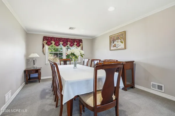 a view of a dining room with furniture and a potted plant