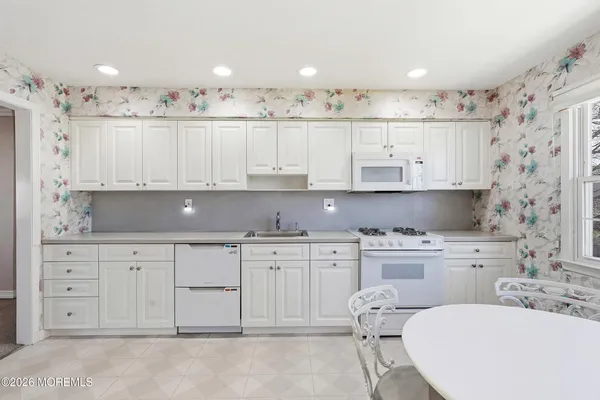 a kitchen with cabinets and window
