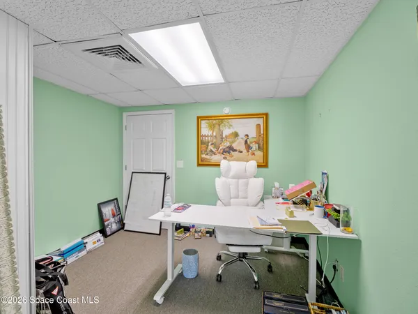 a workspace with furniture and a wooden floor