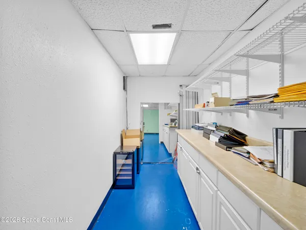 a kitchen with counter top space and wooden floor