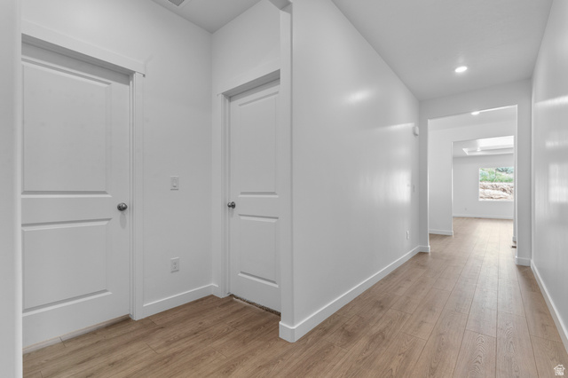 1338 West 2350 South, Unit 19 Perry, UT 84302 - Photo 6 of 14 Hallway featuring wood-finish flooring, recessed lighting, and white walls