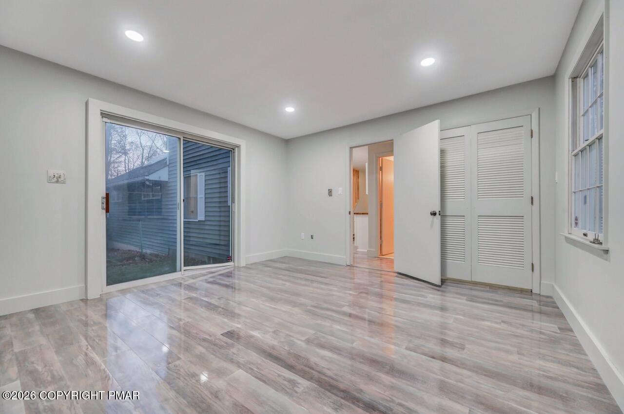 384 Devils Hole Road Cresco, PA 18326 - Photo 36 of 97 a view of an empty room with wooden floor and a window