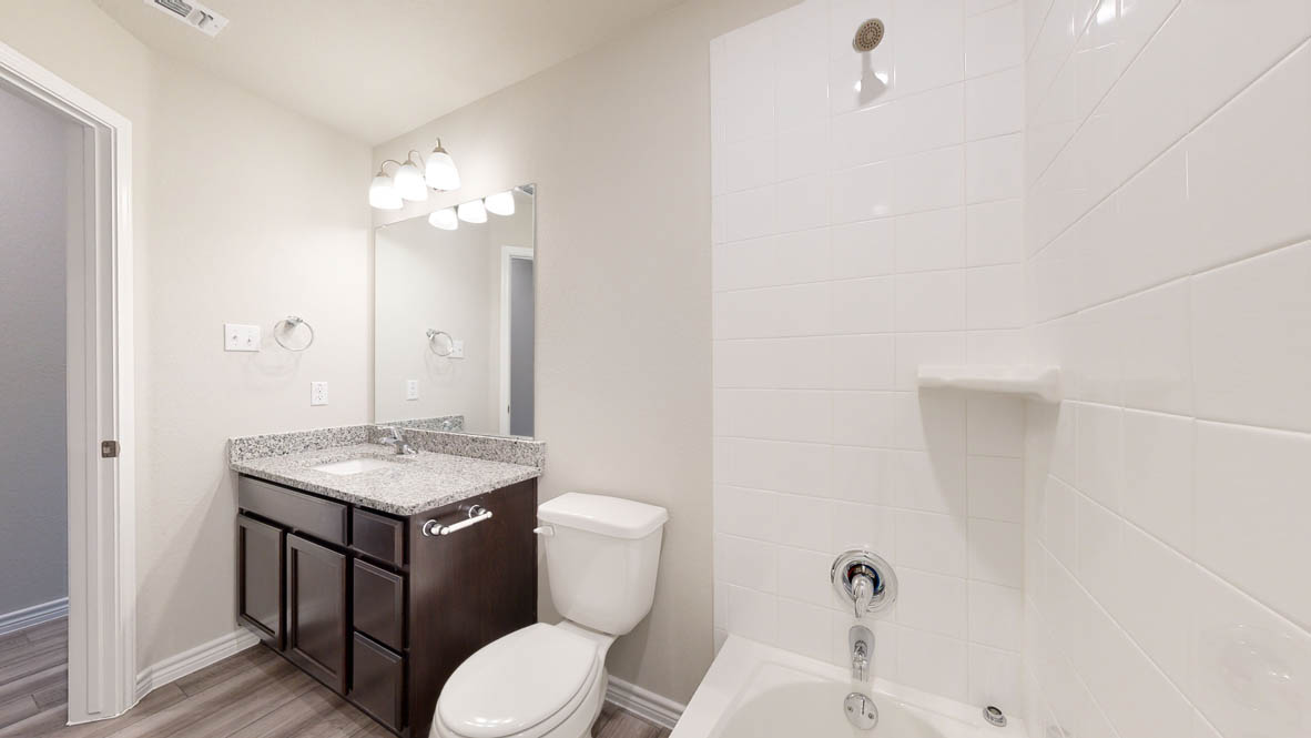 104 Kenzie Street Thorndale, TX 76577 - Photo 25 of 28 a bathroom with a toilet a sink and mirror
