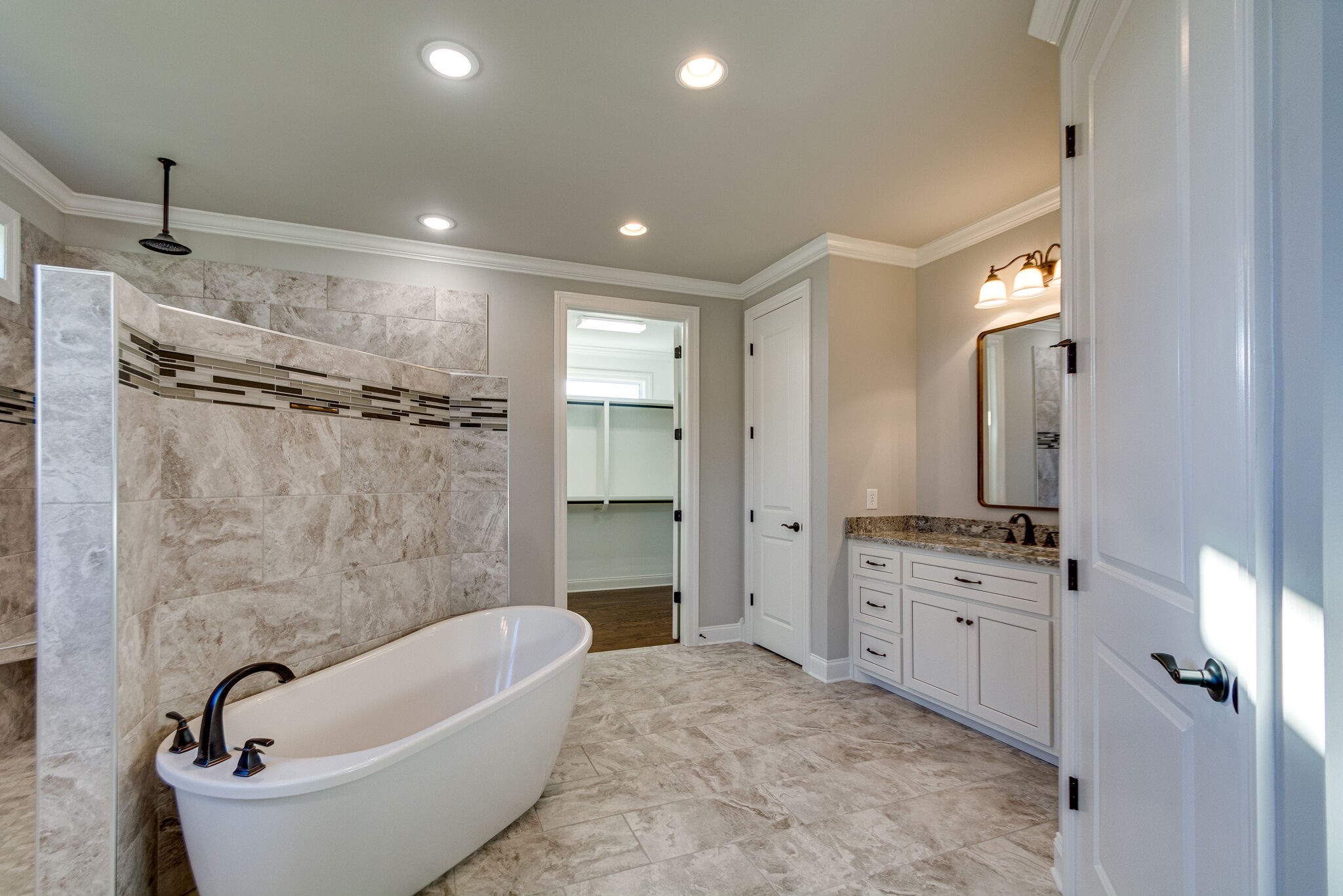 1016 Abbey Rd Way Spring Hill, TN 37174 - Photo 19 of 44 a bathroom with a tub sink shower and mirror