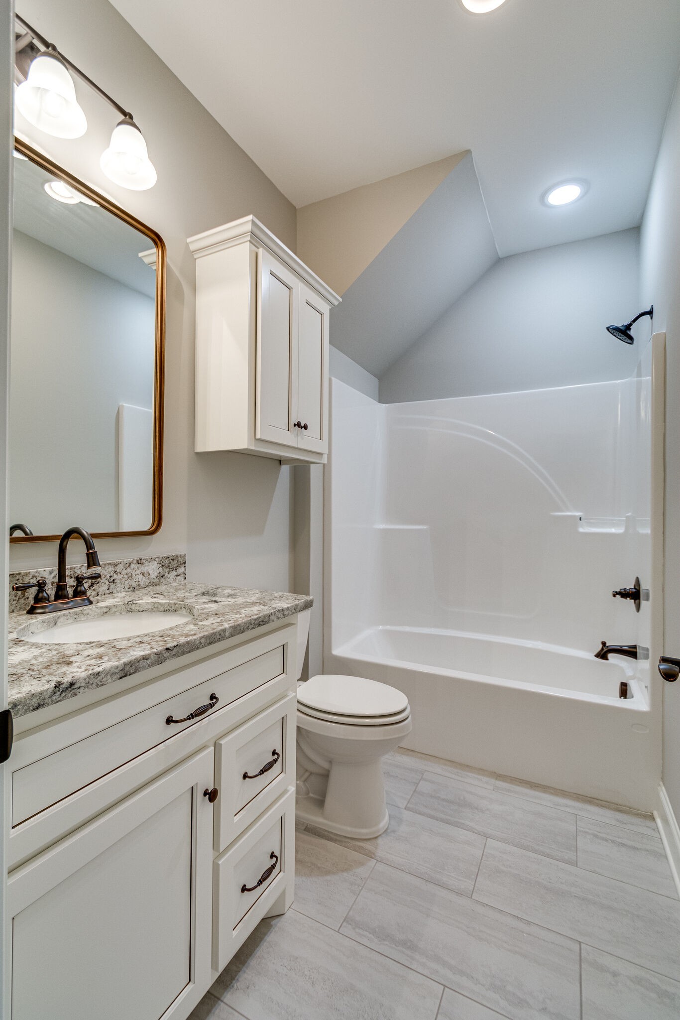 1016 Abbey Rd Way Spring Hill, TN 37174 - Photo 39 of 44 a bathroom with a granite countertop sink a toilet and bathtub