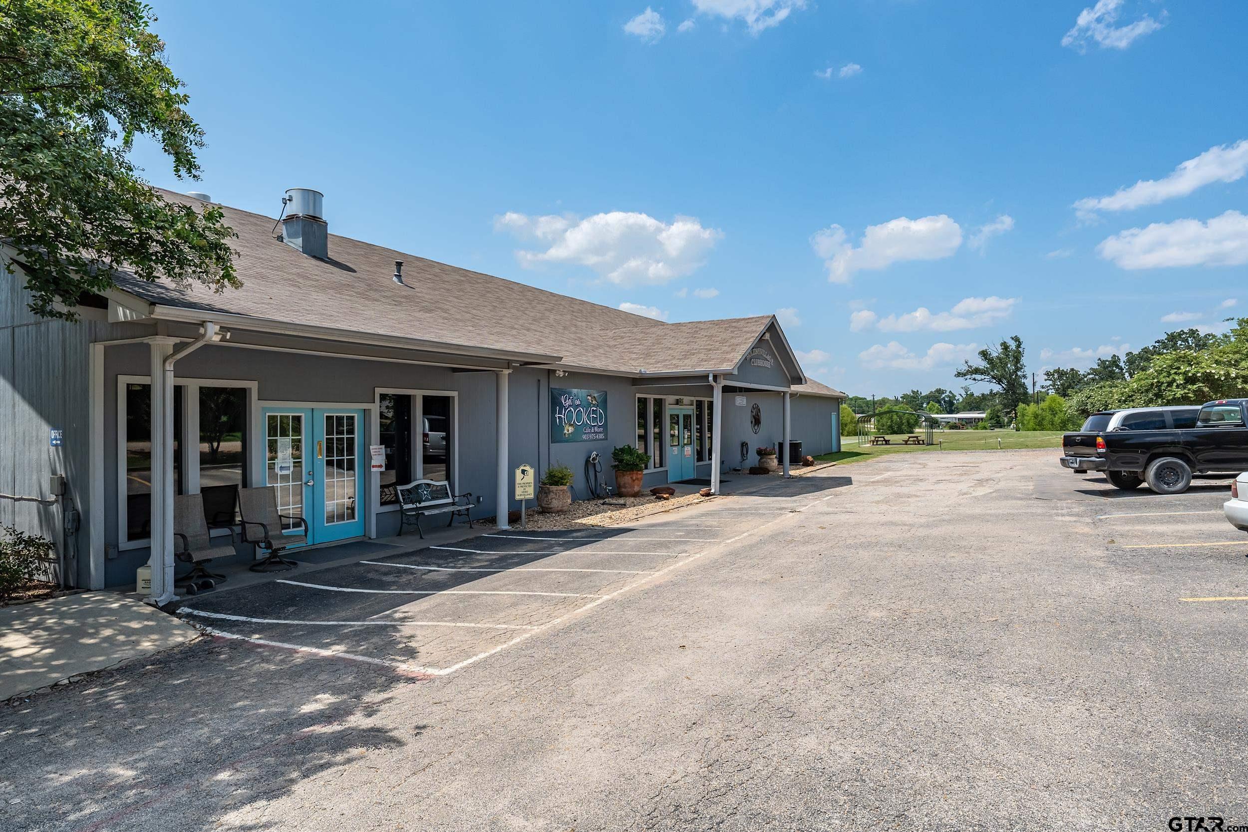 220 Broken Bow Quitman, TX 75783 - Photo 27 of 28 a front view of a house with a yard and table and chairs under an umbrella