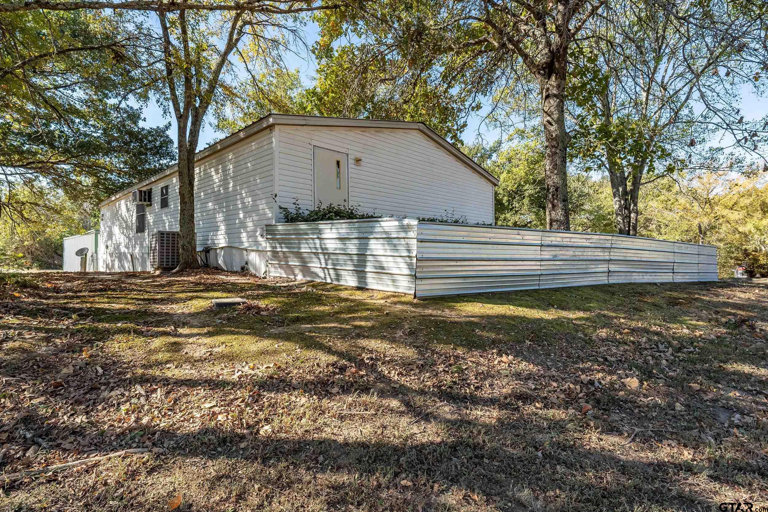 220 Broken Bow Quitman, TX 75783 - Photo 3 of 28 a view of a house with a yard