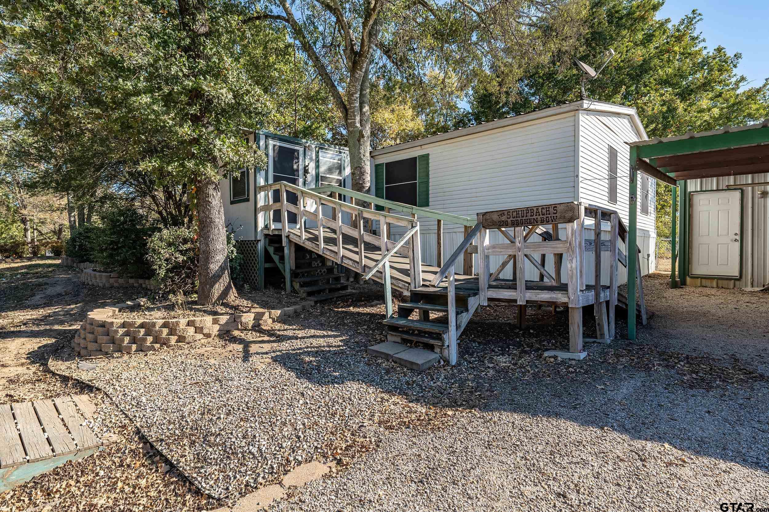 220 Broken Bow Quitman, TX 75783 - Photo 5 of 28 a view of a house with backyard and wooden fence