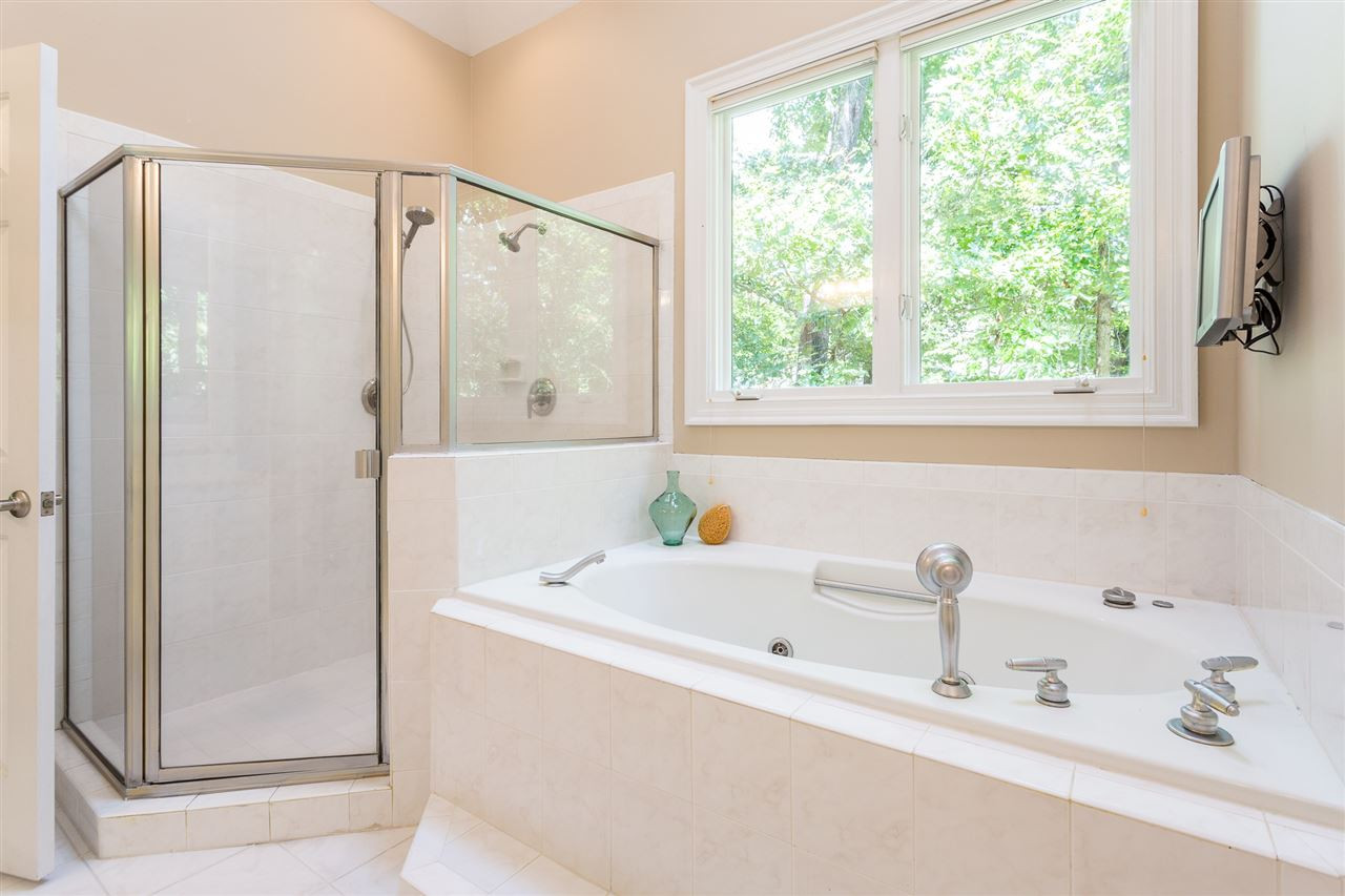 1001 Clingmans Place Raleigh, NC 27614 - Photo 16 of 30 Skylights provide natural light over the jetted tub and walk-in shower w/tile surround. Walk-in Shower and Jetted Tub