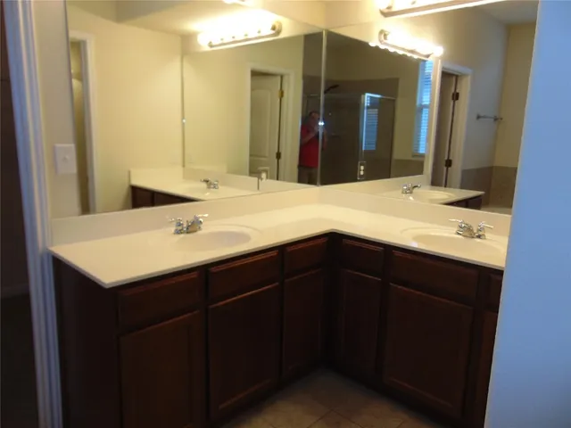 a kitchen with granite countertop a stove sink and cabinets