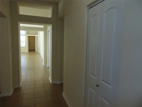 a room with granite countertop a couch and a large window