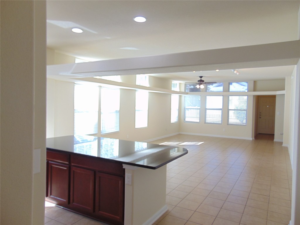 1076 Sanders Kyle, TX 78640 - Photo 12 of 12 a room with granite countertop a couch and a large window