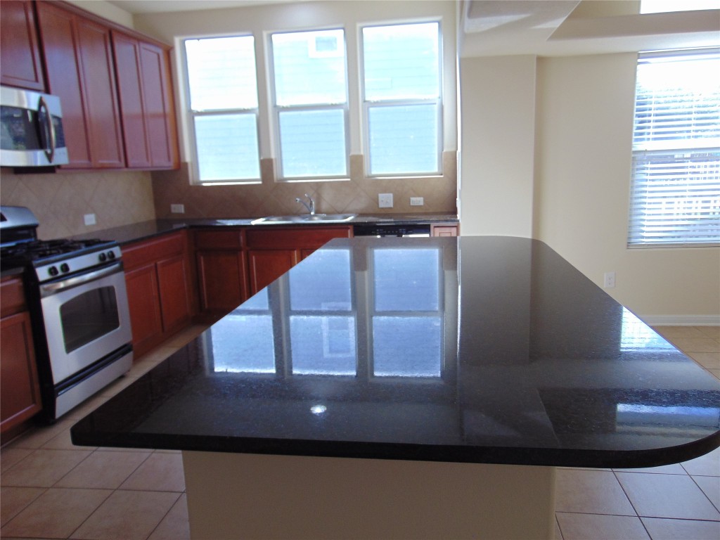1076 Sanders Kyle, TX 78640 - Photo 8 of 12 a kitchen with large window and a sink