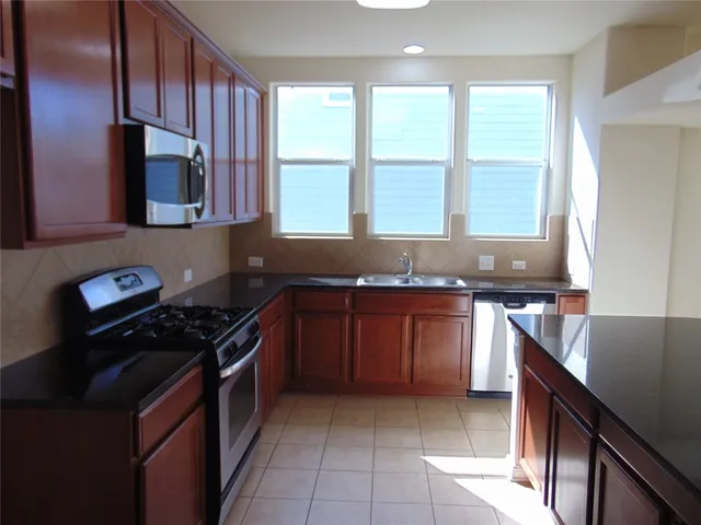 a kitchen with large window and a sink