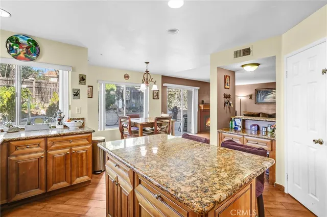 a kitchen with large counter top space sink stove and wooden floor